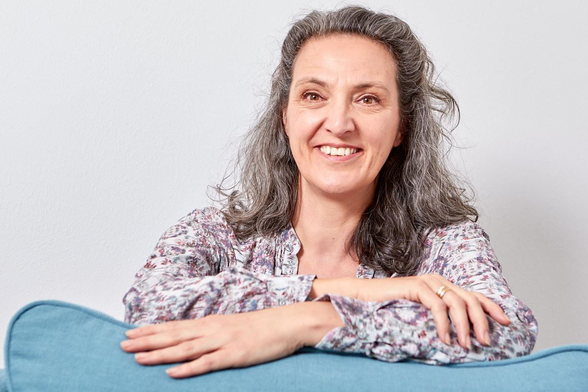 Myriam Schmegner Heilpraktikerin für Psychotherapie lächelnd auf Sessellehne